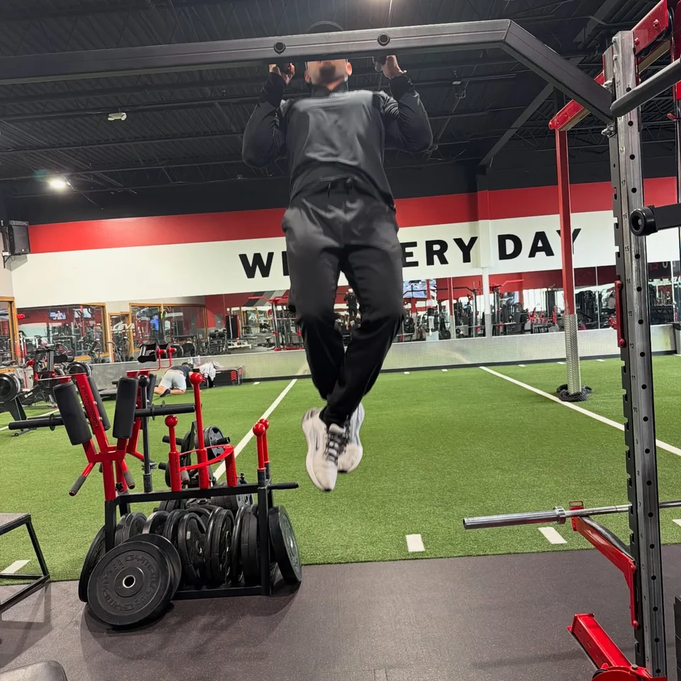 A T3 member performing a pull-up on the training floor